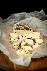 Craft cheese cut into pieces on a cutting board