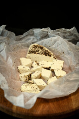 Craft cheese cut into pieces on a cutting board