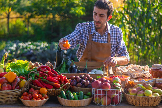 The farmer sells fruits and vegetables at the farmers market. Selective focus.
