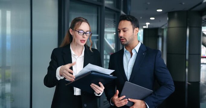 Stressed mad businesswoman boss complains to male employee about bad work results then throws papers in air expressing her disappointment - slow motion tracking