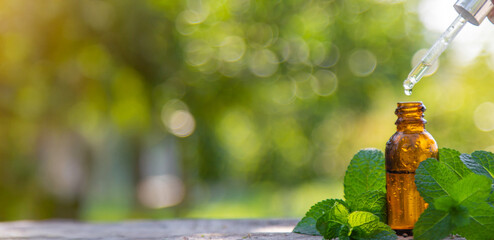 Peppermint essential oil in a bottle. selective focus.