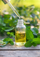 Peppermint essential oil in a bottle. selective focus.