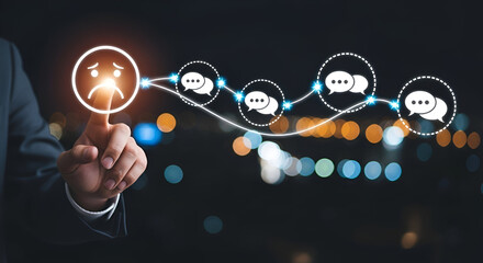 Businessman touching a sad face icon and chat bubbles