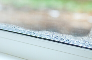 Moisture on a plastic window. Selective focus.