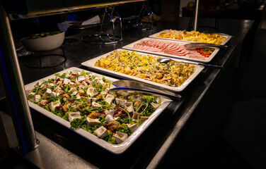 Buffet full of hot and cold dishes in the hotel restaurant during dinner for guests
