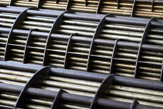 Shell and Tube Heat Exchangers tube bundle baffle details of industrial heat exchanger shell and tube condenser made of steel. Abstract industrial background of steel heat exchanger tube bundles.