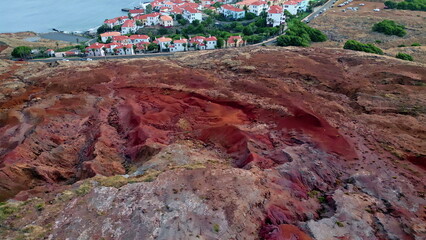 Drone town placed seaside stone terrain. Small coastal city with red roof houses