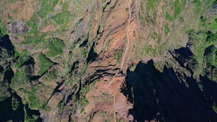 Mountain cliffs green vegetation top view. Picturesque rocky walls at sunlight. 