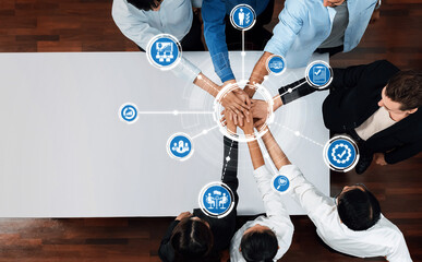 A dynamic scene capturing professionals uniting their hands, symbolizing teamwork and collaboration...