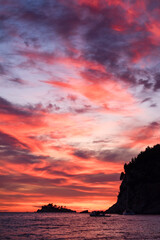 Montenegro, Europe: a fiery sunset on Buljarica beach, one of the largest beaches of the coast, close to Petrovac in direction of Bar (Budva municipality)
