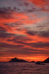 Montenegro, Europe: a fiery sunset on Buljarica beach, one of the largest beaches of the coast, close to Petrovac in direction of Bar (Budva municipality)
