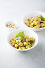 Chicken with celery, zucchini and pine nuts