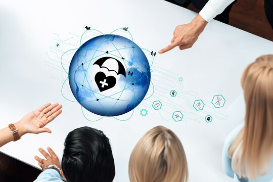 A diverse team collaborates in a modern workspace, brainstorming solutions around a digital globe featuring health icons and connectivity symbols, showcasing innovation and teamwork. Trope - Powered by Adobe