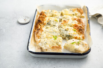 Four cheese pizza on a tray