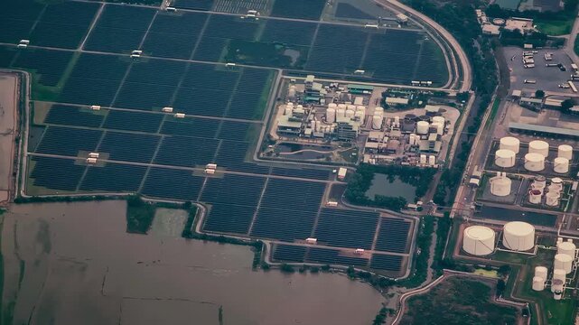 A Combined-Cycle Power Plant generates electricity by burning natural gas and reusing waste heat, making it both environmentally friendly and economically viable. Bird's eye view by drone. 