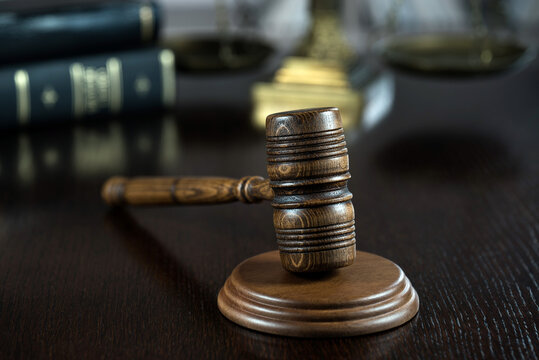wooden judge gavel on table in courtroom - Powered by Adobe