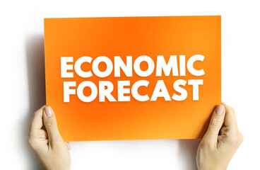 ECONOMIC FORECAST text on background held by hands. Business and finance concept for data analysis, market prediction, and future economic trends