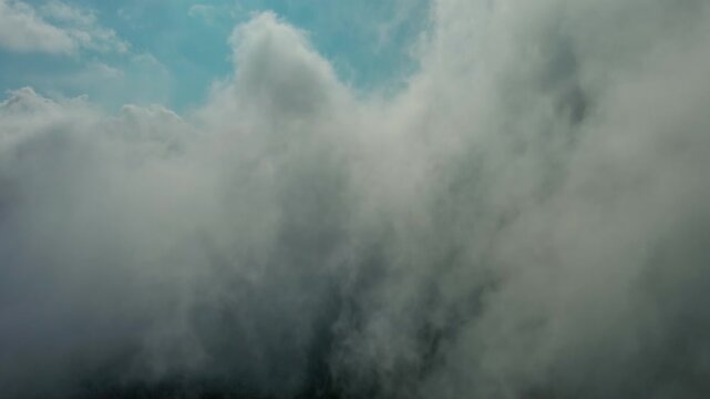 Aerial high view of clouds and blue sky, flying in clouds, 4k