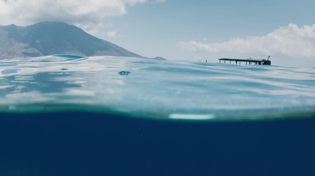 Splitted underwater view of the tropical sea. Indonesia, Alor island