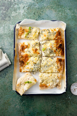 Four cheese pizza on a tray