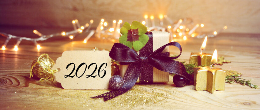 New Year 2026 background banner with copy space - Lucky clover leaves with magical bokeh lights and gift box - clover, shamrock, good luck
