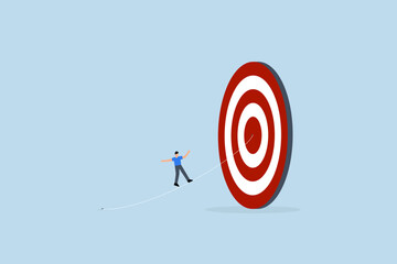 Set goal and take action to achieve goal or target, businessman walking on line aiming at target bullseye