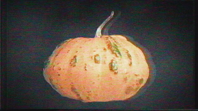 Spinning, Floating Pumpkin with Retro TV Glitch Effect in Seamless Loop