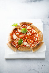 Traditional Pepperoni pizza with fresh basil