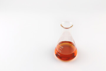 chemical beaker , flask is on white table with blotting paper , fragrance bottle and essential oil bottle are used to blend the nice scent for making perfume and candle by perfumer in the laboratory