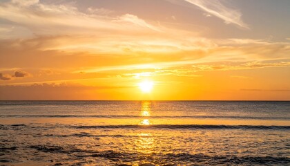 Fototapeta premium Serene sunset over calm ocean waters, with golden hues reflecting on the surface and soft clouds