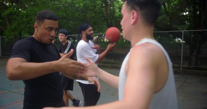 Friends celebrating after basketball game on outdoor court, sharing dap handshakes, laughter, and friendly energy in a joyful urban sports moment of camaraderie and respect