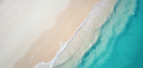Aerial view of turquoise sea and white sand beach. Waves wash ashore on tropical coast. Paradise scenic seascape view. Summer vacation holiday at sea resort shoreline.