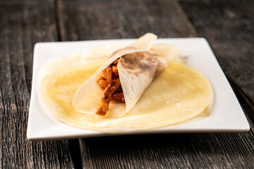 Hoisin chicken pancakes on a wooden background. Chinese cuisine. Asian food. Food concept