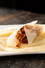 Hoisin chicken pancakes on a wooden background. Chinese cuisine. Asian food. Food concept