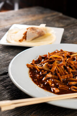 Hoisin chicken pancakes on a wooden background. Chinese cuisine. Asian food. Food concept