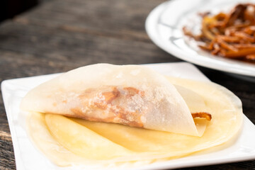 Hoisin chicken pancakes on a wooden background. Chinese cuisine. Asian food. Food concept
