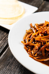 Hoisin chicken pancakes on a wooden background. Chinese cuisine. Asian food. Food concept
