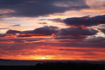dramatic sunset after a storm with vivid colors and heavy clouds