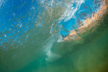 Underwater view of wave moving into the beach shore.