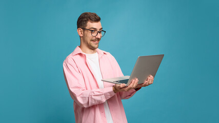 Surprised man looking at laptop screen with funny shocked face expression. Concept of social media...