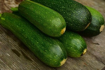 Green zucchini on wooden table. Harvesting zucchini, fresh , ripe , organic vegetables. Food rustic background.
