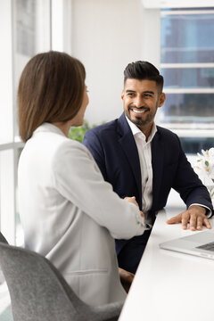 Cheerful confident young Indian business professional man shaking hands