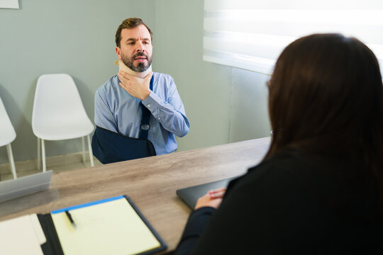 Injured client discussing accident insurance claim with agent