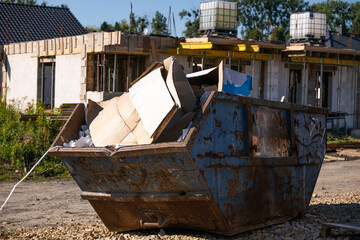 Large Rusty Dumpster Filled with Construction Waste