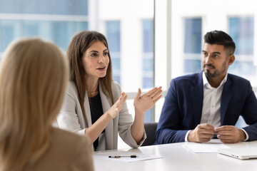 Positive business professional woman offering creative ideas for team brainstorming