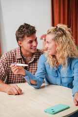 Joyful couple sharing a heartfelt moment as they look at the results of a pregnancy test with excitement and anticipation in their eyes, embodying the essence of love and family planning.
