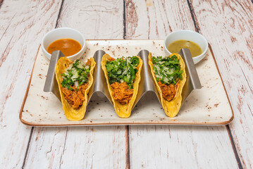 Pressed pork rind tacos with crispy skin, drunken salsa, and cooked nopales in warm tortillas