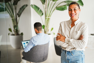 Latin american business woman smiling on camera inside corporate office - Female entrepreneur concept - Focus on face