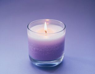 Aromatic purple candle burning in a glass jar for relaxation