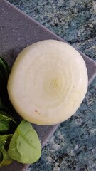 Close-up of a peeled onion on a cutting board